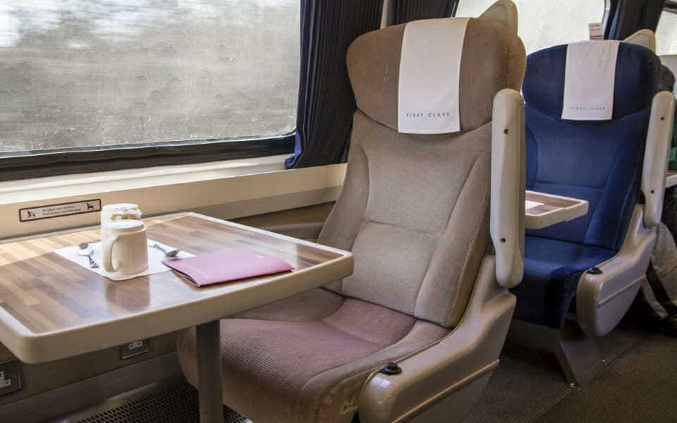 first class train carriage with table seats
