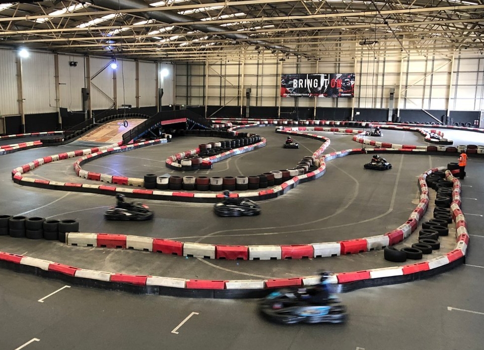 TeamSport Go Karting tarmac track in Manchester surrounded by walls with go-karts travelling at speed